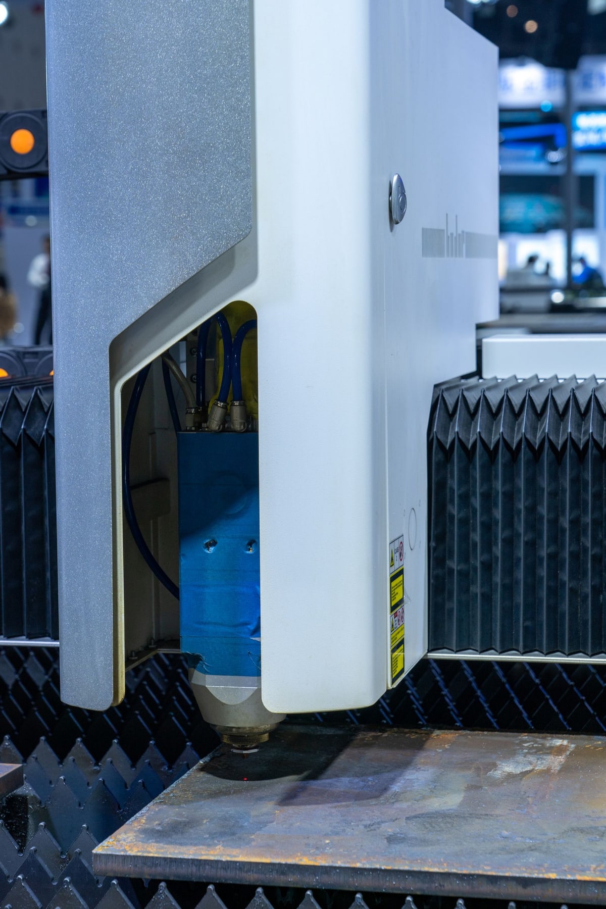 Laser cutting machine processing a metal sheet